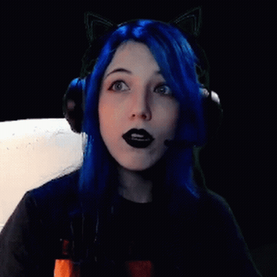 A Girl With Blue Hair And Black Lipstick Is Wearing Headphones And Cat Ears . GIF