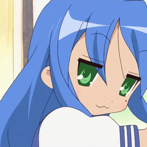 A Girl With Blue Hair And Green Eyes Is Looking At The Camera GIF
