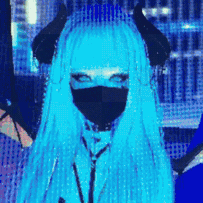 A Girl With Blue Hair And Horns Is Wearing A Mask And Has Blue Eyes . GIF