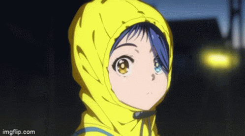 A Girl With Blue Hair And Yellow Eyes Is Wearing A Yellow Jacket With A Hood . GIF