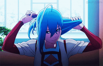 A Girl With Blue Hair Is Brushing Her Hair With A Brush GIF
