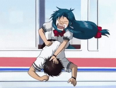 A Girl With Blue Hair Is Fighting A Boy On The Floor . GIF