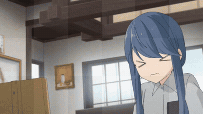 A Girl With Blue Hair Is Making A Funny Face In A Room GIF