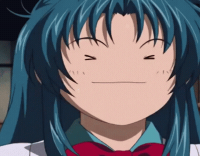 A Girl With Blue Hair Is Making A Funny Face With Her Eyes Closed GIF