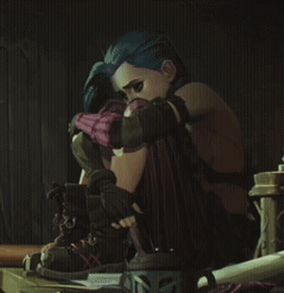 A Girl With Blue Hair Is Sitting On A Table With Her Head On Her Knees GIF