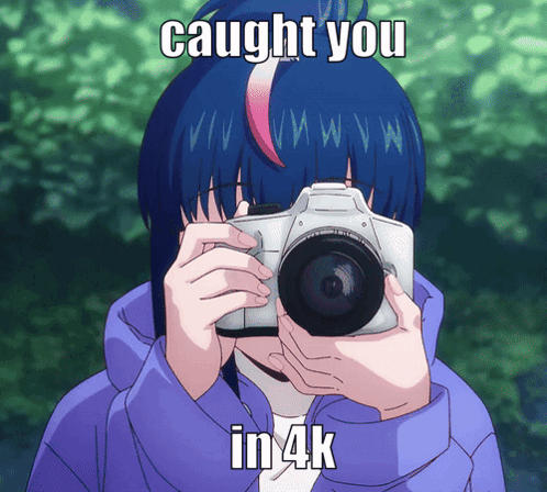A Girl With Blue Hair Is Taking A Picture With A Camera And The Caption Caught You In 4K GIF