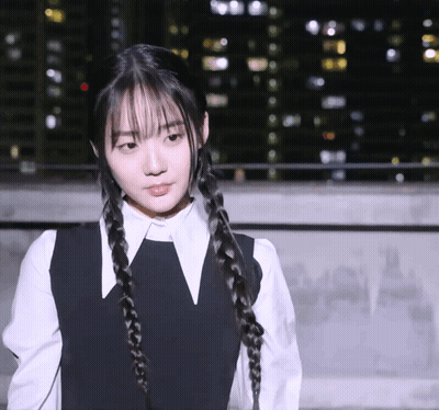 A Girl With Braids And A White Shirt Has A V On Her Collar GIF