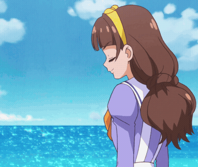 A Girl With Brown Hair And A Yellow Headband Is Looking Down At The Ocean GIF
