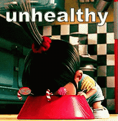 A Girl With Candy In Her Hair Is Sitting In A Red Bowl With The Words Unhealthy Written Above Her GIF