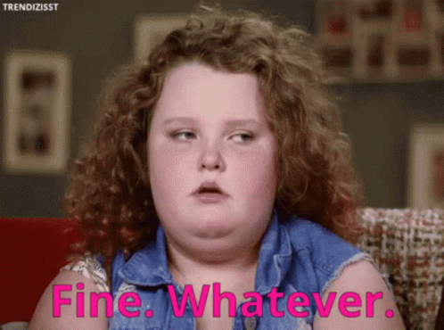 A Girl With Curly Hair Is Sitting On A Couch And Says Fine Whatever GIF