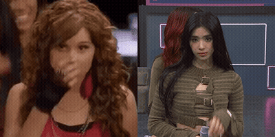 A Girl With Curly Hair Is Standing Next To Another Girl GIF