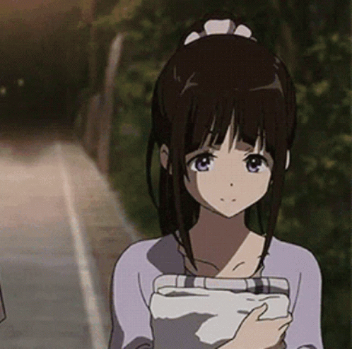 A Girl With Dark Hair Is Holding A Piece Of Paper GIF