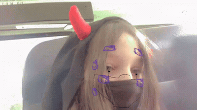 A Girl With Devil Horns On Her Head And A Hello Kitty Face Mask GIF