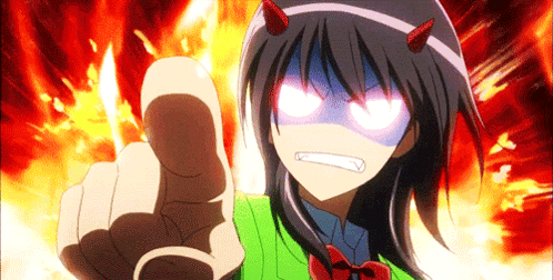 A Girl With Devil Horns On Her Head Is Pointing At The Camera GIF