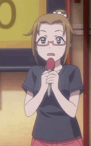 A Girl With Glasses Is Holding A Red Microphone In Her Hands GIF