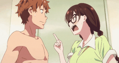 A Girl With Glasses Is Pointing At A Shirtless Guy GIF