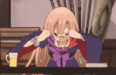 A Girl With Glasses Is Sitting At A Table With A Mug Of Beer GIF
