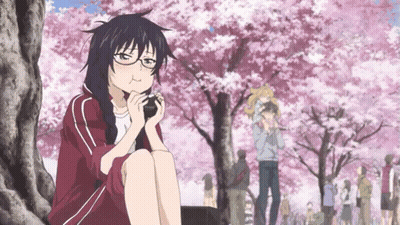 A Girl With Glasses Is Sitting Under A Tree Eating Something GIF