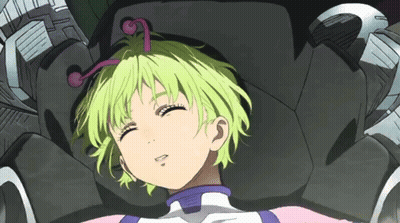 A Girl With Green Hair Is Laying In A Chair GIF