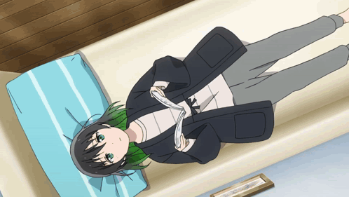 A Girl With Green Hair Is Laying On A Bed With A Picture In The Background GIF