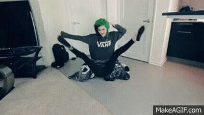 A Girl With Green Hair Is Sitting On A Man 'S Lap With Her Legs Outstretched . GIF