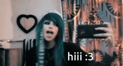 A Girl With Green Hair Is Taking A Selfie With A Cell Phone . GIF