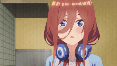 A Girl With Headphones Around Her Neck Is Looking At Something GIF