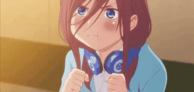A Girl With Headphones Around Her Neck Is Making A Face GIF