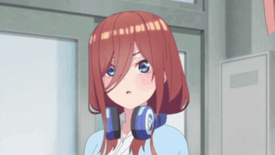 A Girl With Headphones Around Her Neck Is Standing In Front Of A Building . GIF