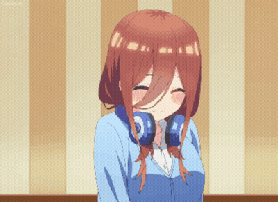A Girl With Headphones Around Her Neck Makes A Funny Face GIF