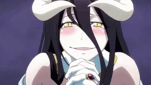 A Girl With Horns And A Ring On Her Finger Is Smiling And Looking At The Camera . GIF