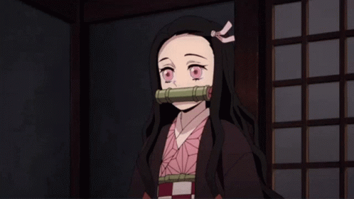 A Girl With Long Black Hair And A Pink Bow In Her Hair Is Standing In A Dark Room GIF