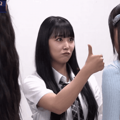 A Girl With Long Black Hair Giving A Thumbs Up Sign GIF