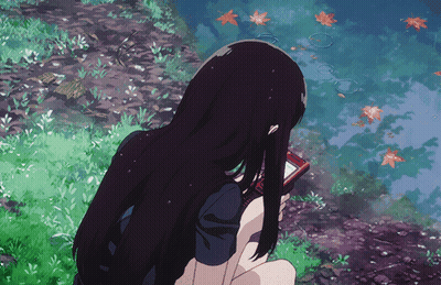 A Girl With Long Black Hair Is Holding A Cell Phone In Her Hand GIF