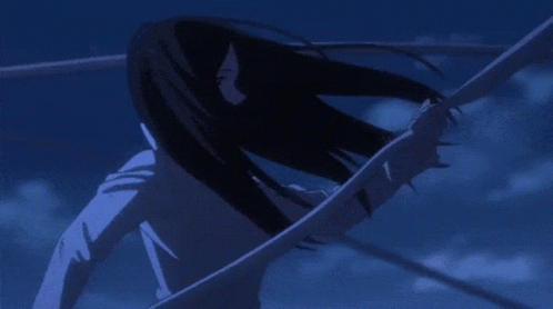 A Girl With Long Black Hair Is Standing In A Dark Room GIF