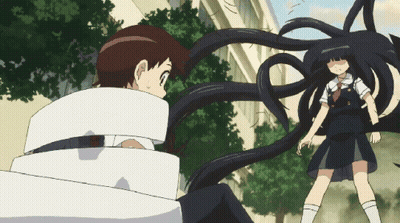 A Girl With Long Black Hair Is Standing Next To A Boy Who Is Wrapped In White Tape GIF