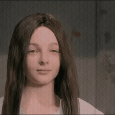 A Girl With Long Dark Hair Is Wearing A Wig GIF