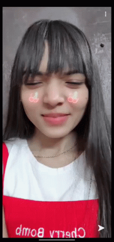 A Girl With Long Hair And Bangs Is Wearing A Red Apron GIF