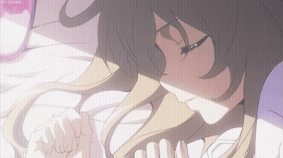 A Girl With Long Hair Is Laying On A Bed GIF
