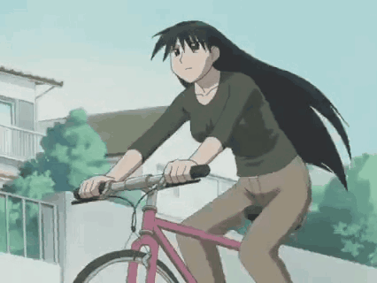 A Girl With Long Hair Is Riding A Pink Bicycle GIF