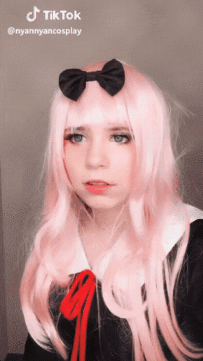 A Girl With Long Pink Hair And A Black Bow On Her Head Has A Tiktok Watermark GIF