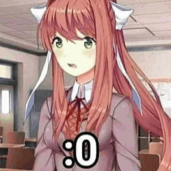 A Girl With Long Red Hair And Green Eyes Is Standing In A Classroom Wearing A School Uniform . GIF