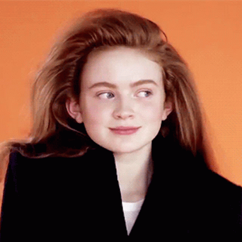 A Girl With Long Red Hair Wearing A Black Jacket GIF