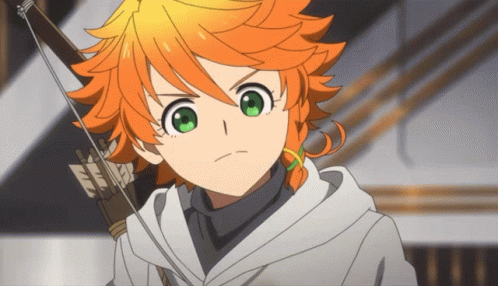 A Girl With Orange Hair And Green Eyes Is Holding A Bow GIF