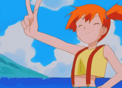 A Girl With Orange Hair Is Giving A Peace Sign In Front Of The Ocean GIF