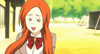 A Girl With Orange Hair Is Making A Funny Face With Her Eyes Closed GIF