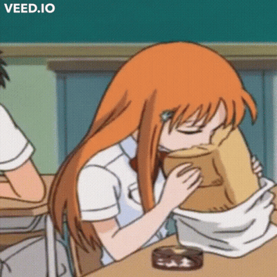 A Girl With Orange Hair Is Sitting At A Desk With Her Eyes Closed And A Bag On Her Head .. GIF