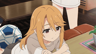A Girl With Orange Hair Is Sitting At A Table With A Soccer Ball In The Background GIF