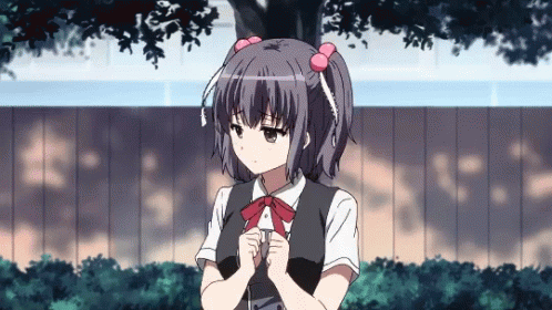 A Girl With Pigtails And A Bow Tie Is Standing In Front Of A Fence GIF