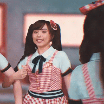 A Girl With Pigtails And A Flower In Her Hair Is Dancing GIF